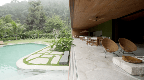 Laranjeiras house blends seamlessly with nature, using sustainable design and natural materials to harmonize with its surroundings.