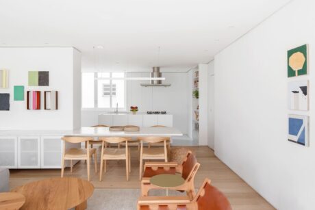A modern kitchen and dining room featuring wooden furniture, showcasing a blend of contemporary design and historic architecture.