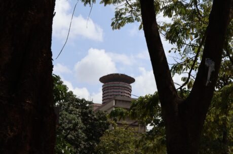 Pan-African Biennale of Architecture — the cylindrical tower and saucer-shaped crown of the Kenyatta International Convention Centre rising above trees in Nairobi