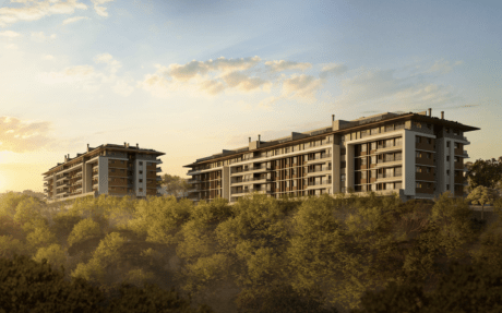 Alameda by ARQOS in Santana de Parnaíba, São Paulo, two low-rise residential blocks with balconies and green roofs rising above dense treetops at sunset